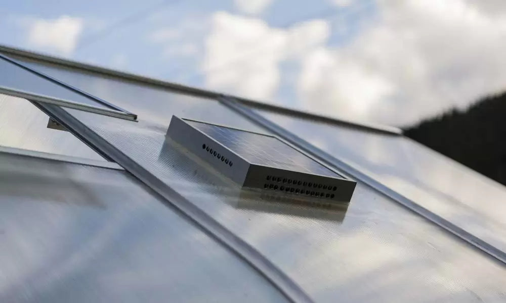 Solar-powered ventilation fan on the greenhouse roof