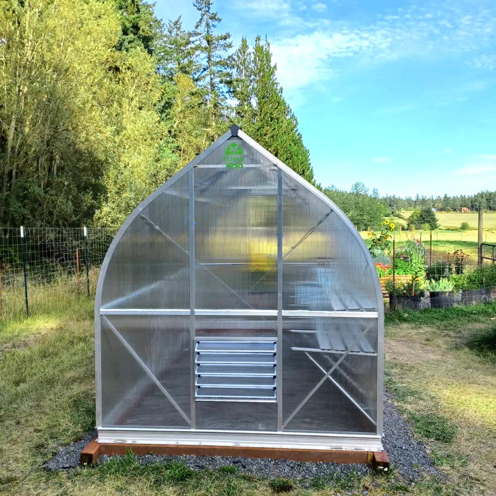 ClimaPod Spirit 7x14 Greenhouse in a garden with trees and clear sky