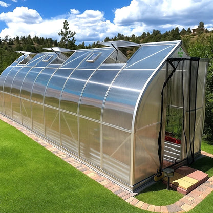 Gotic arch polycarbonate greenhouse 7x21 on a grassy area with trees in the background.