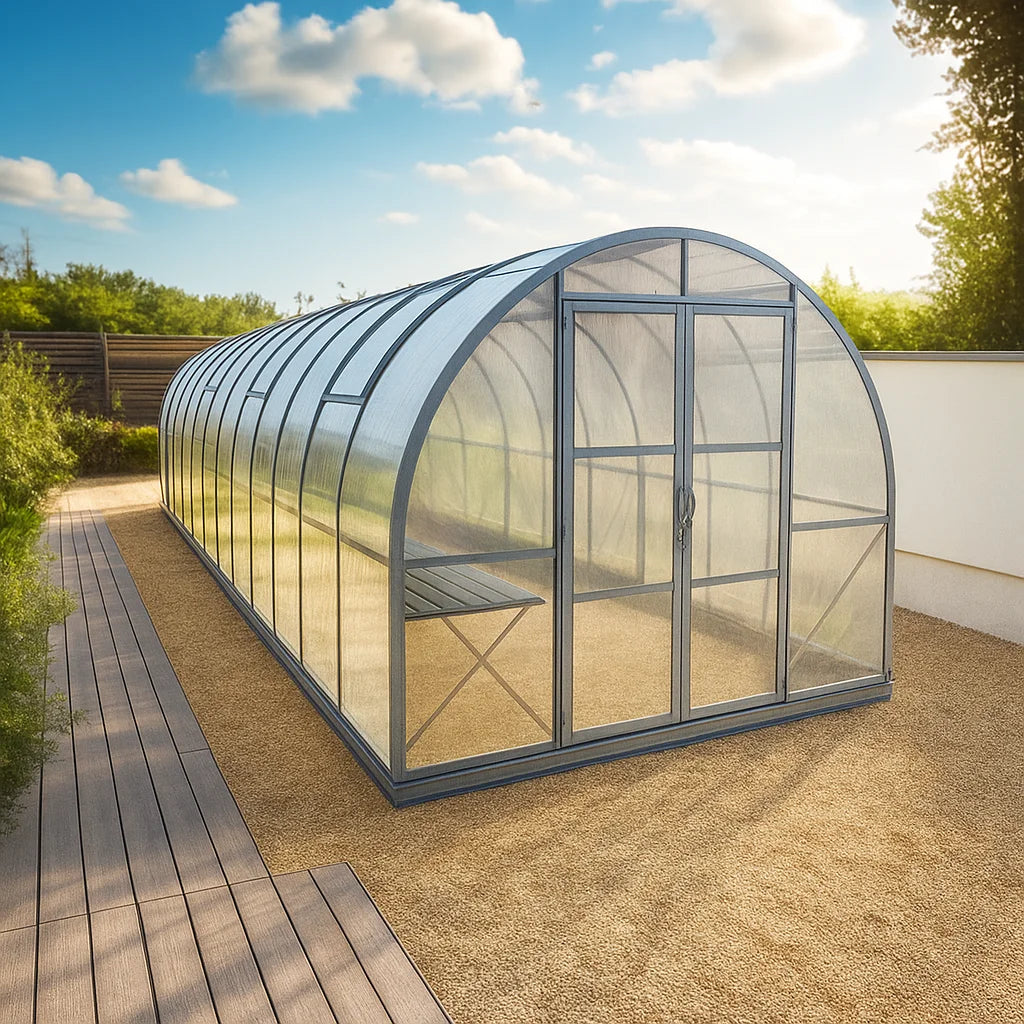 Polycarbonate greenhouse on a gravel with a clear sky and trees in the background