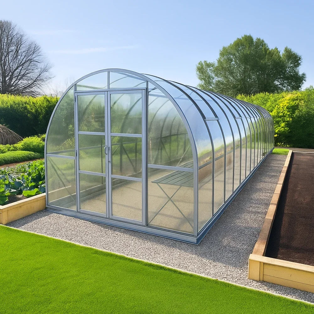 9x42 polycarbonate greenhouse in a garden setting with greenery and clear sky