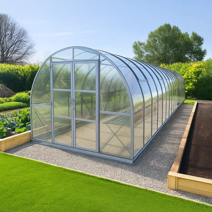 9x42 polycarbonate greenhouse in a garden setting with greenery and clear sky